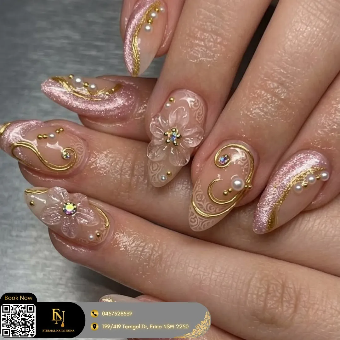Ornate rose shimmer nails with gold swirls, pearls, and a raised flower