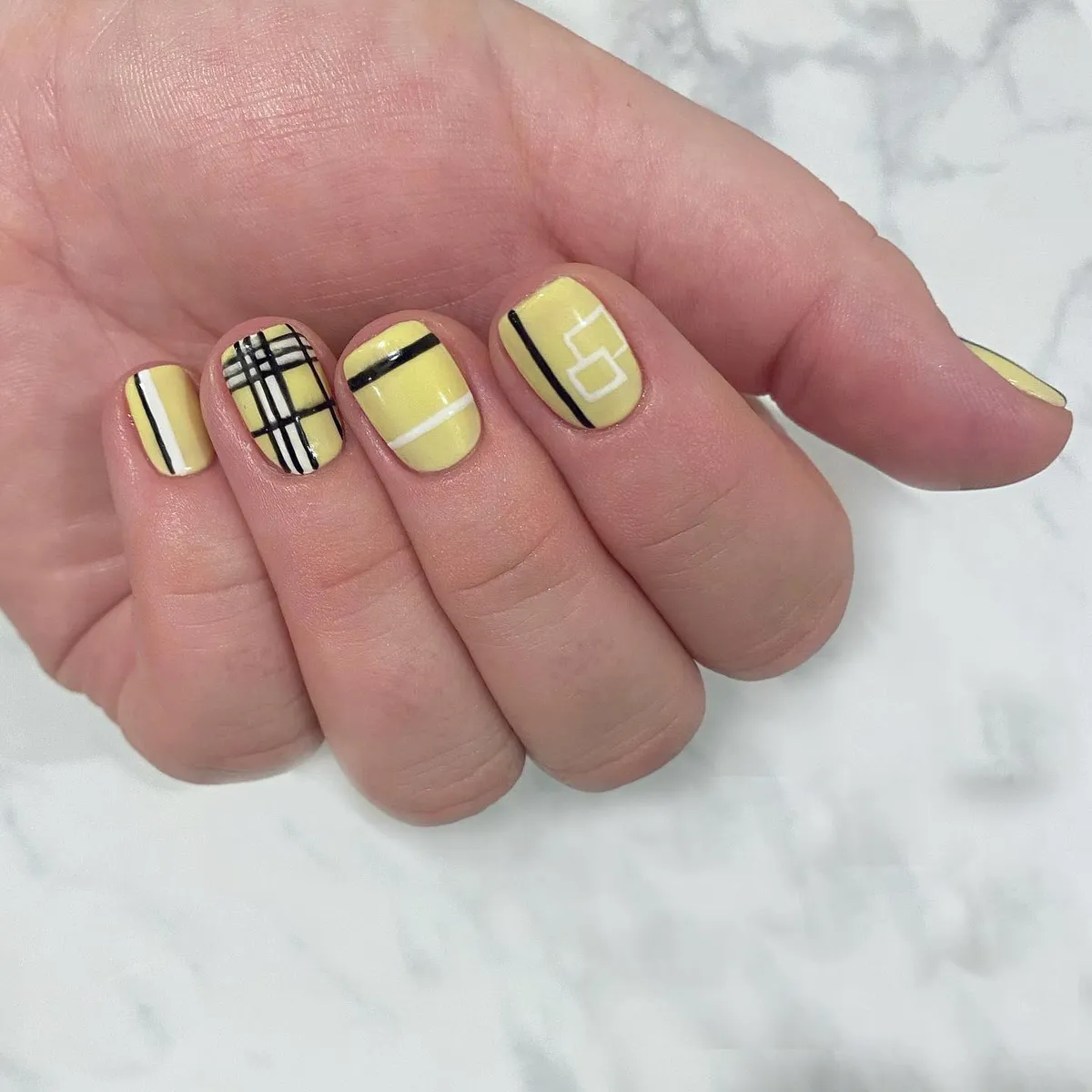 Pale yellow with black-and-white plaid and graphic lines