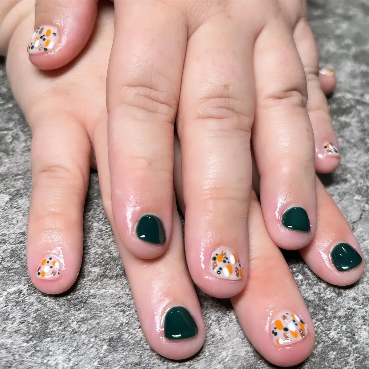 Dark green solids with confetti-style accent nails