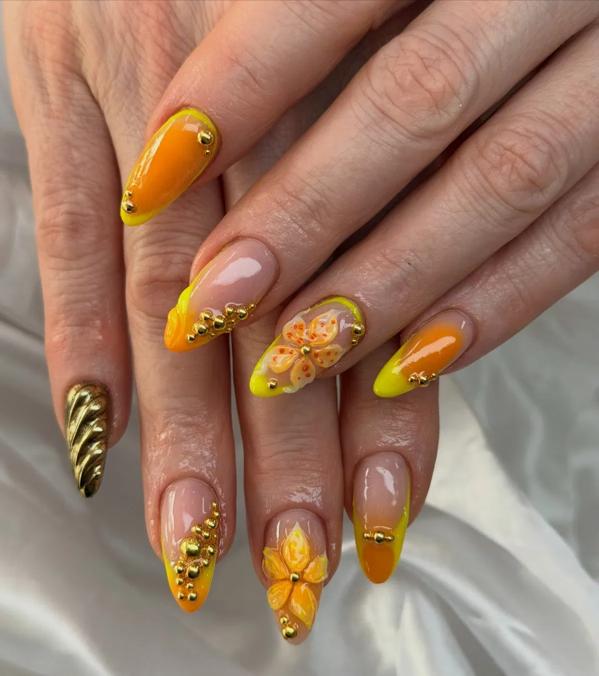 Short glossy yellow nails with simple floral-grid accents