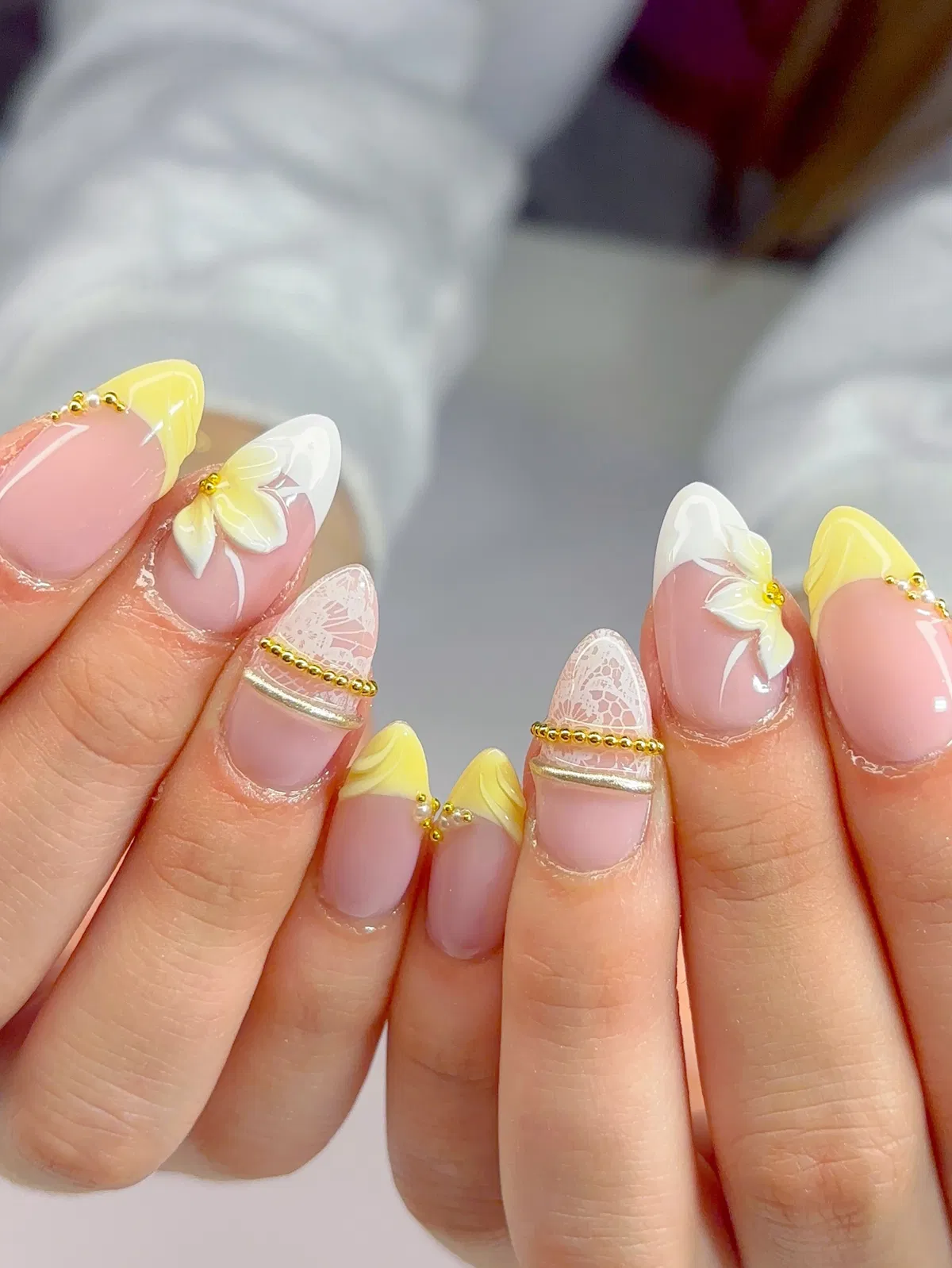 Polka-dot yellow tips with gold chain lines and butterfly accent