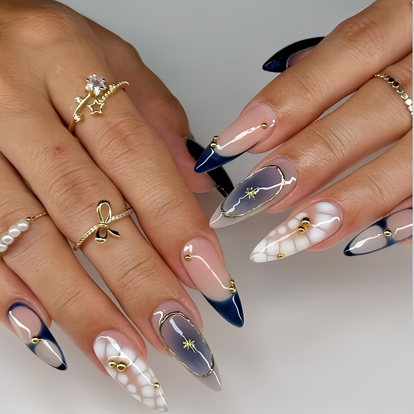 Blue French tips with gold outlines and star motifs