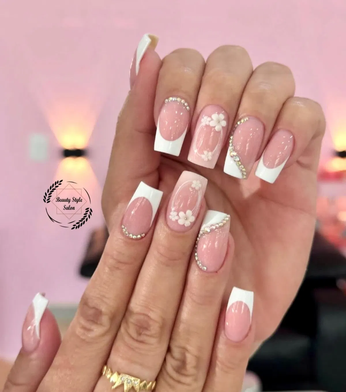 White French tips with rhinestone curves and small white flowers