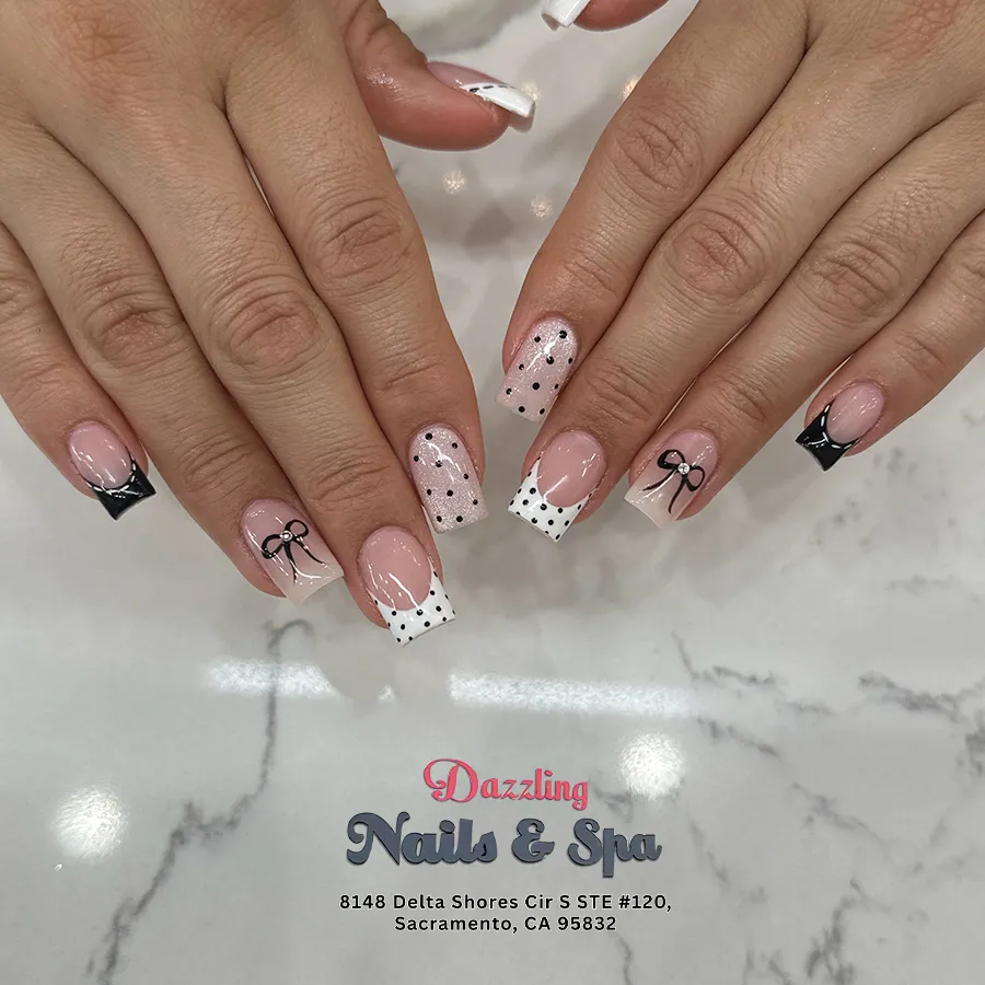 Mixed white/black French tips with polka dots and bow accents
