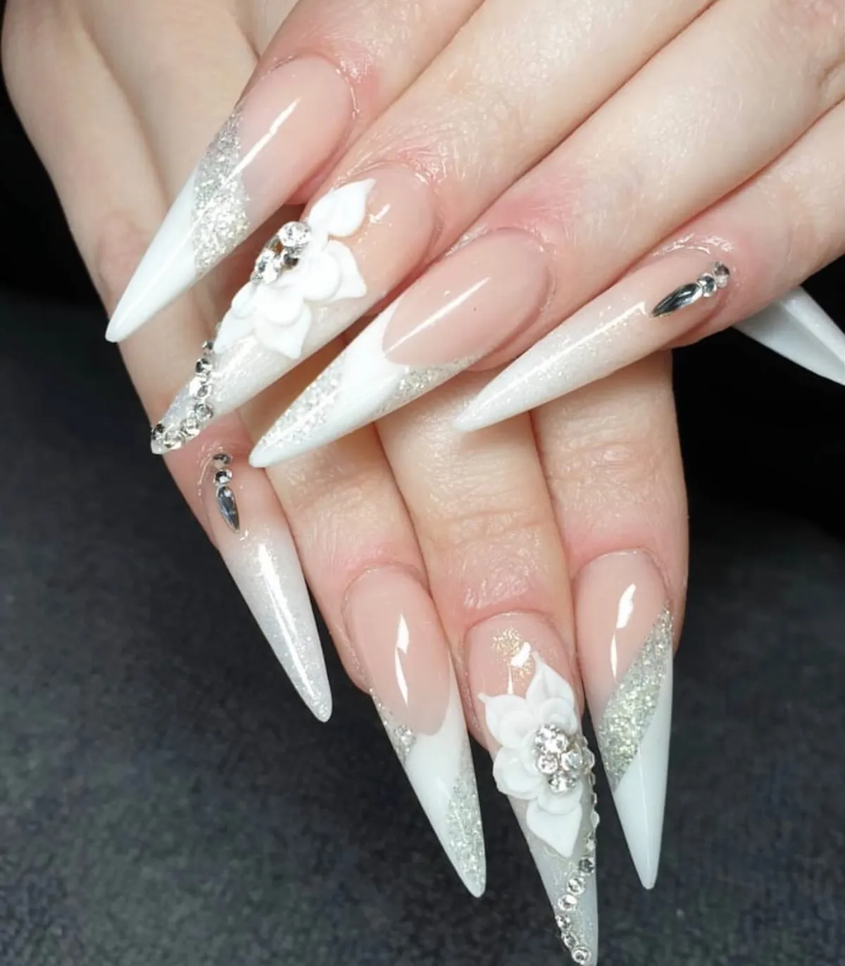 Stiletto white tips with silver gradient and statement flowers