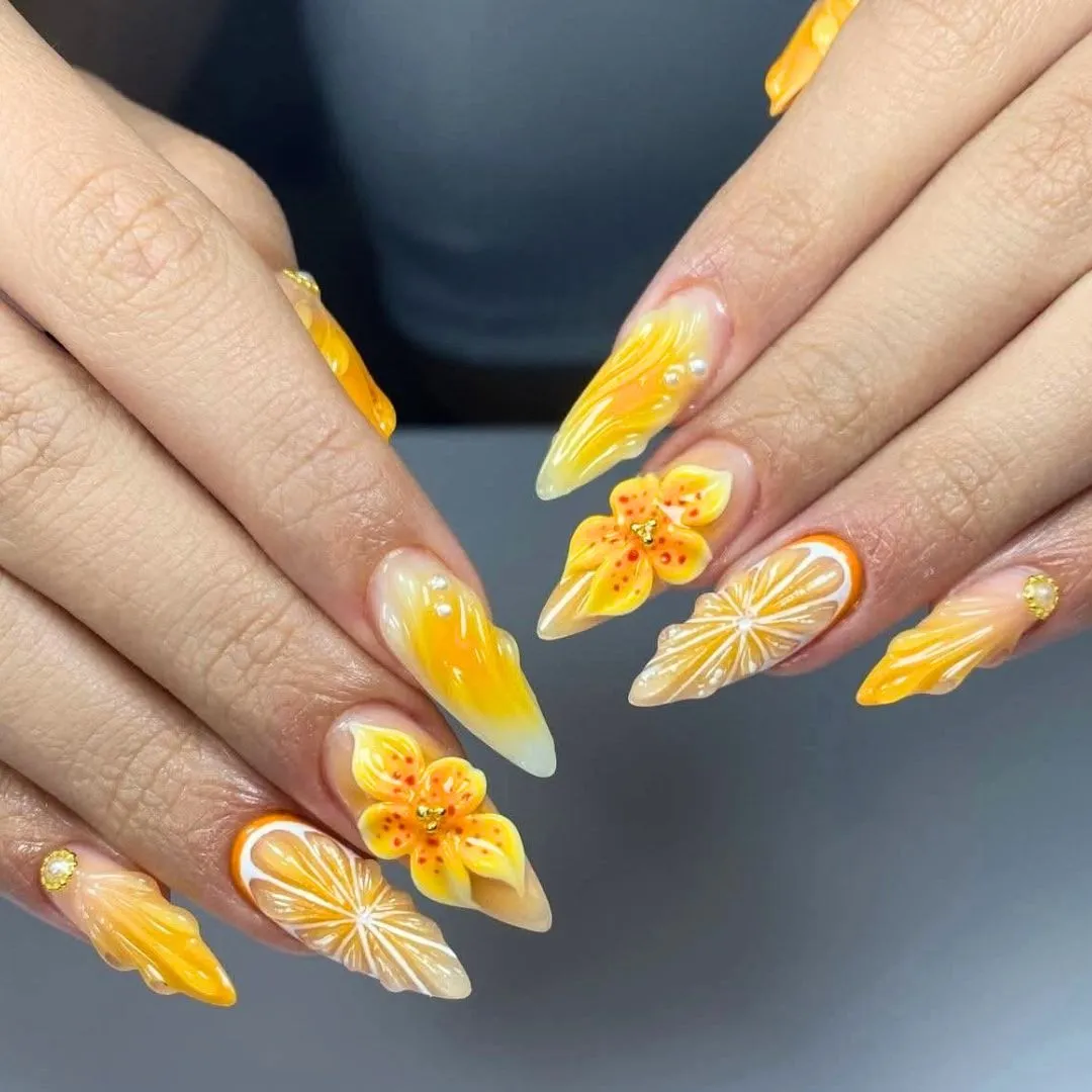 Yellow ombrΓ© stiletto nails with citrus and 3D flowers