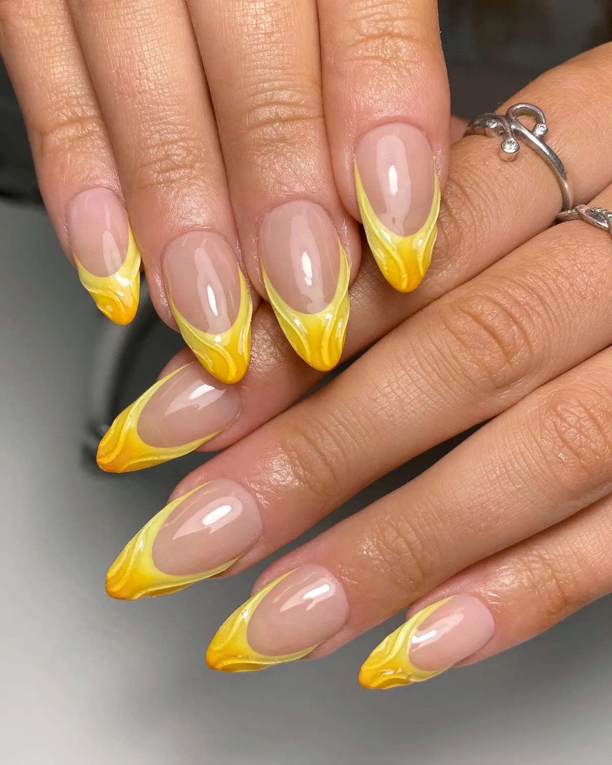 Swirled yellow French tips on nude base