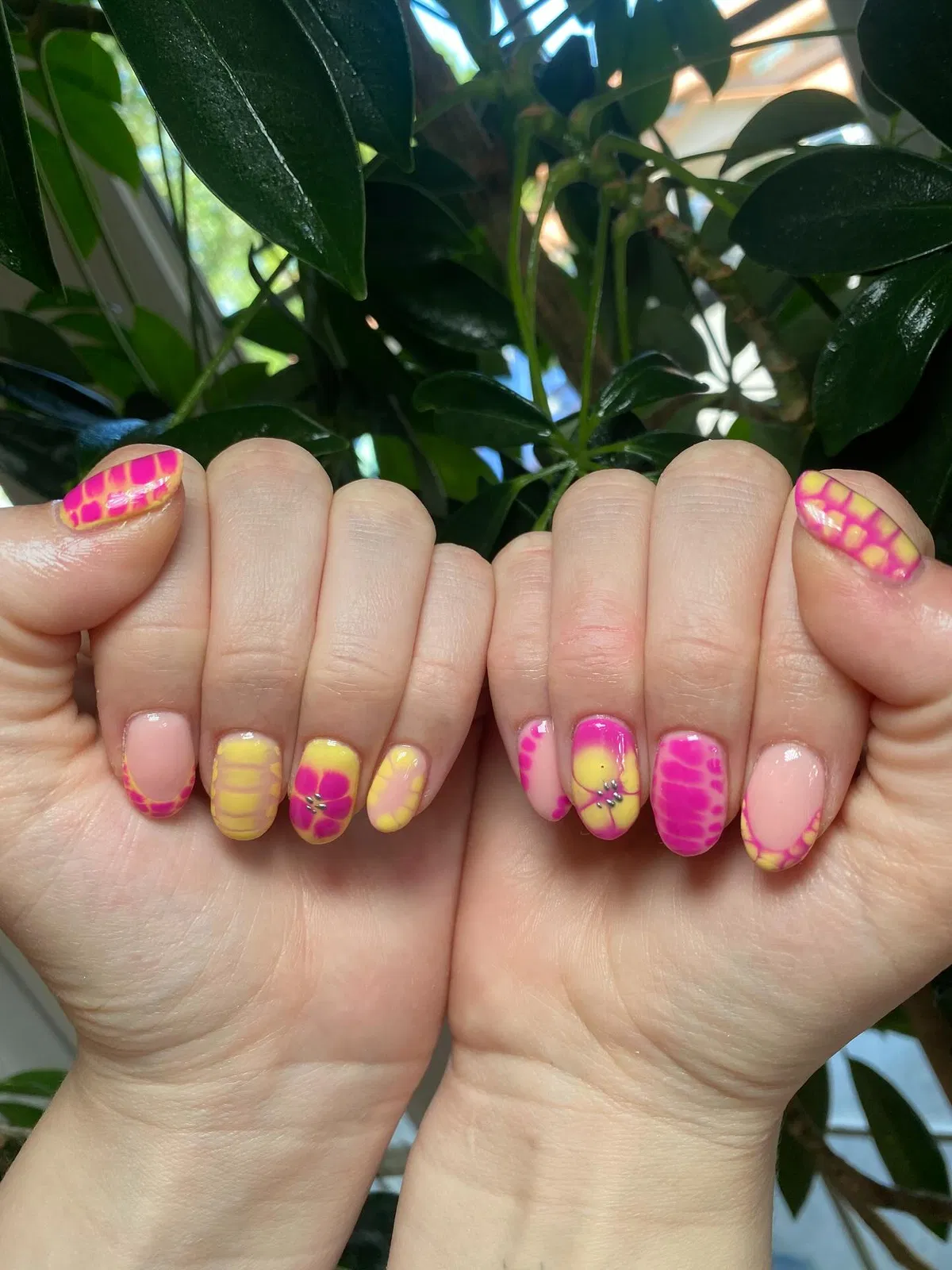 Pink-and-yellow marbled patterns with small stud accents