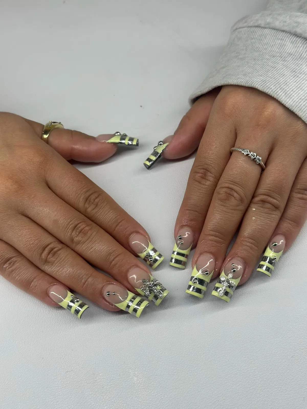Striped yellow tips with silver bows and studs