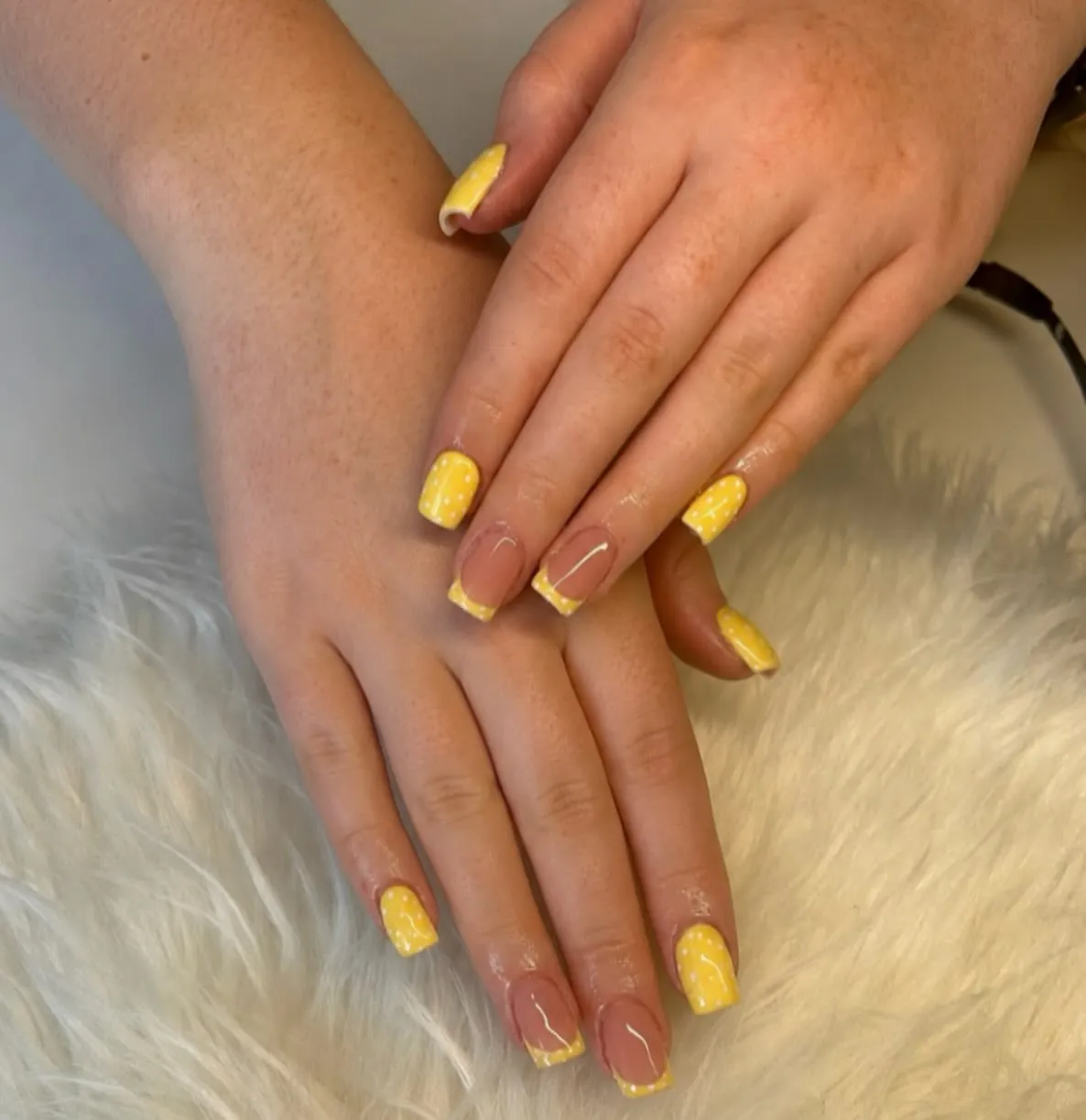 Yellow French tips with white speckle accents