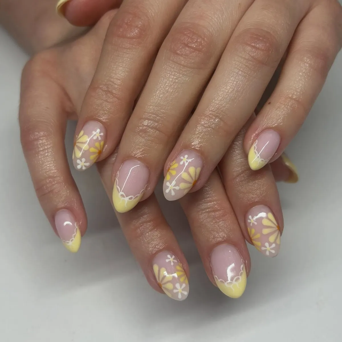 Scalloped Yellow French tips with daisy-style florals