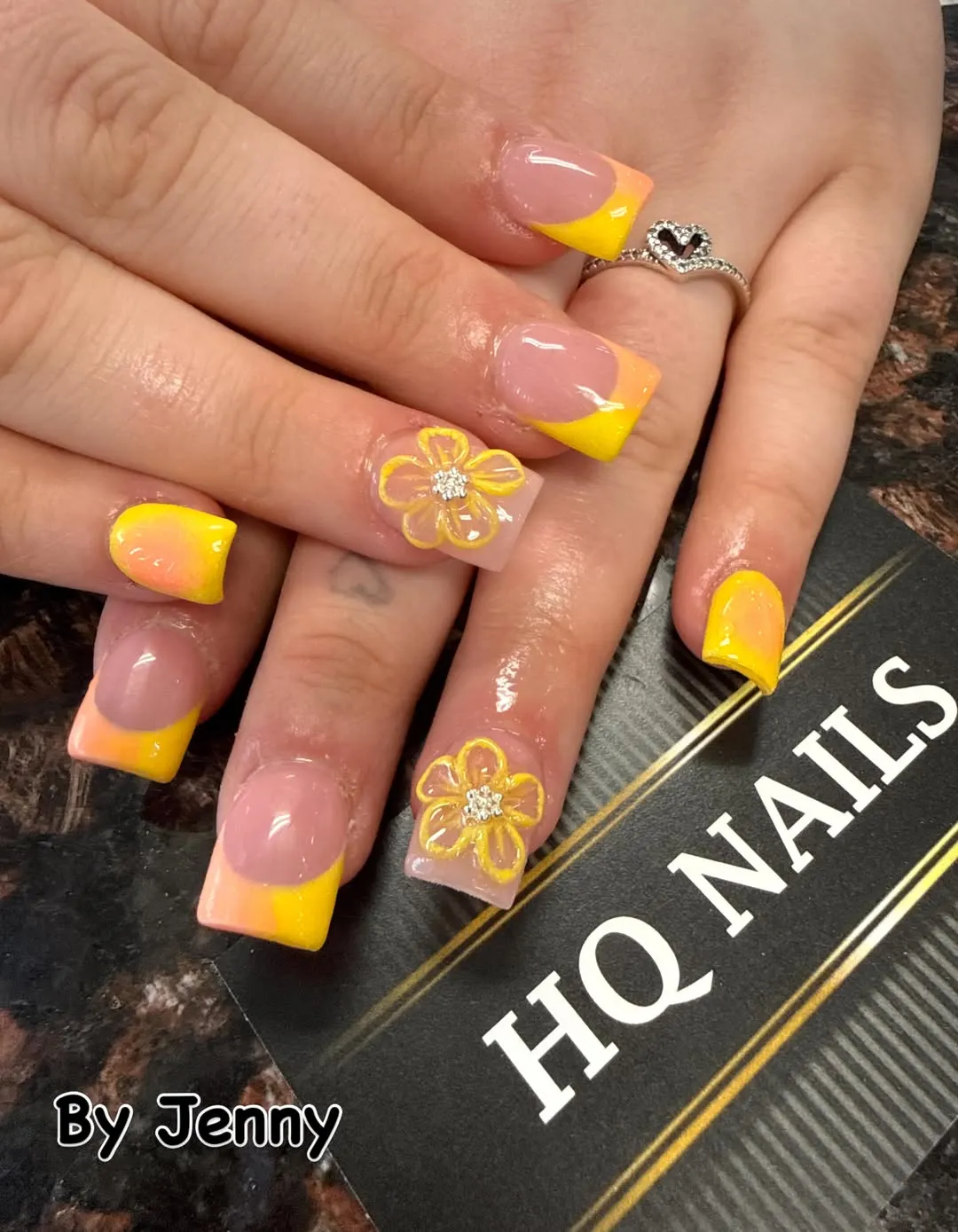 Yellow-to-orange French tips with outlined flower accents