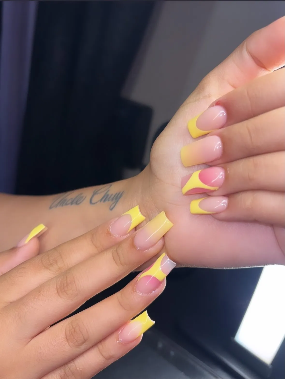 Yellow French tips with curved pink-and-yellow color blocking