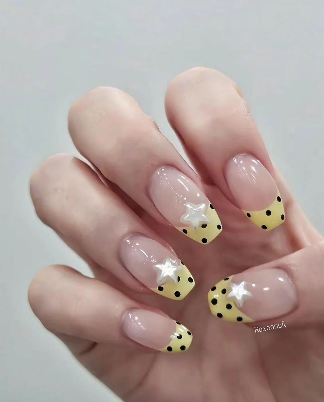 Polka-dot yellow French tips with raised white stars