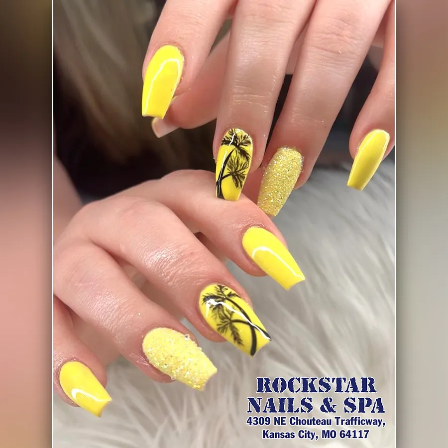Bright yellow nails with palm silhouettes and glitter accents