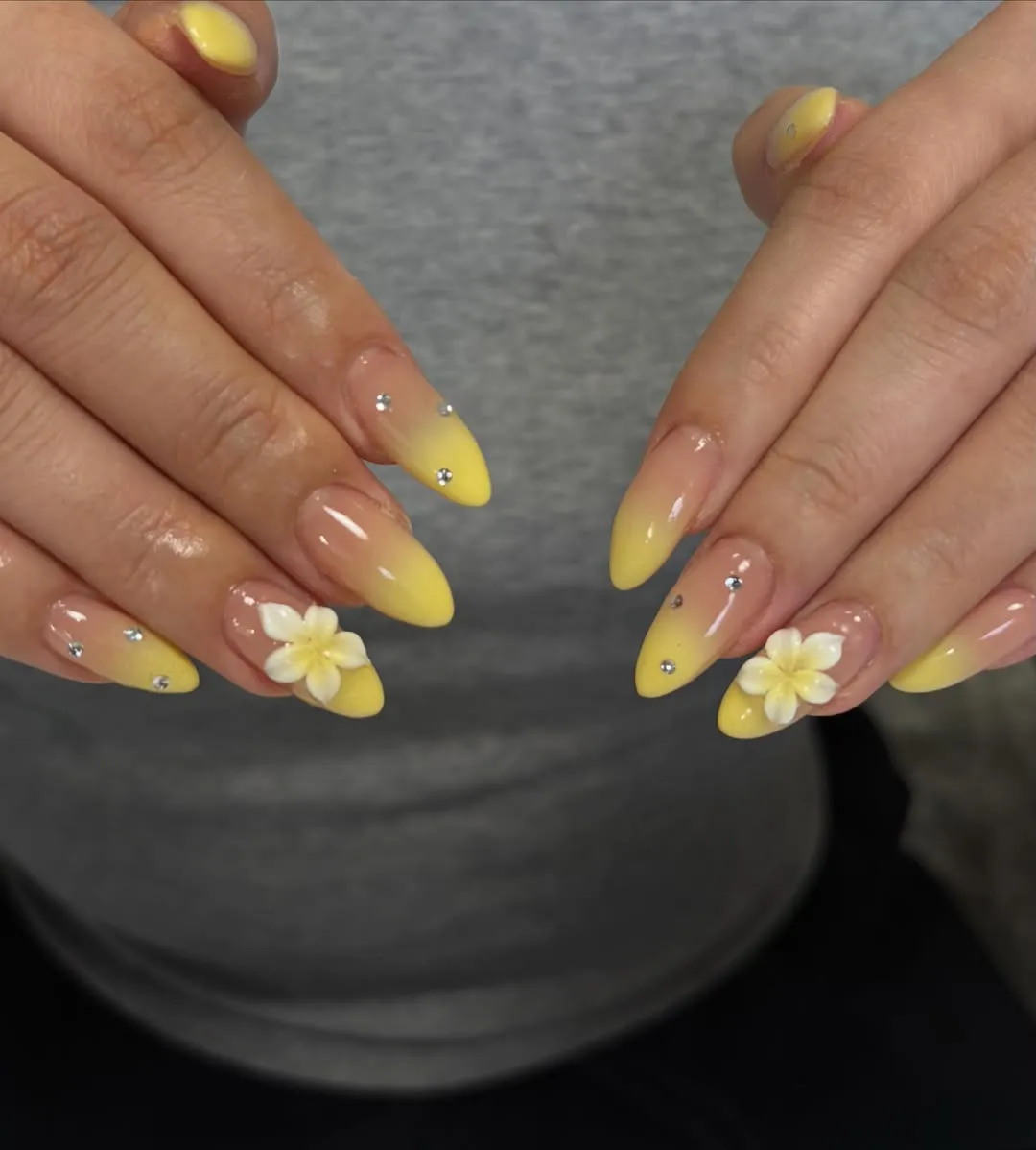 Soft yellow ombre almond nails with rhinestones and 3D flowers
