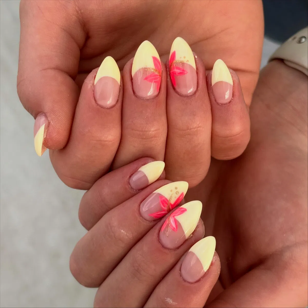 Pale yellow French tips with hot-pink leaf strokes