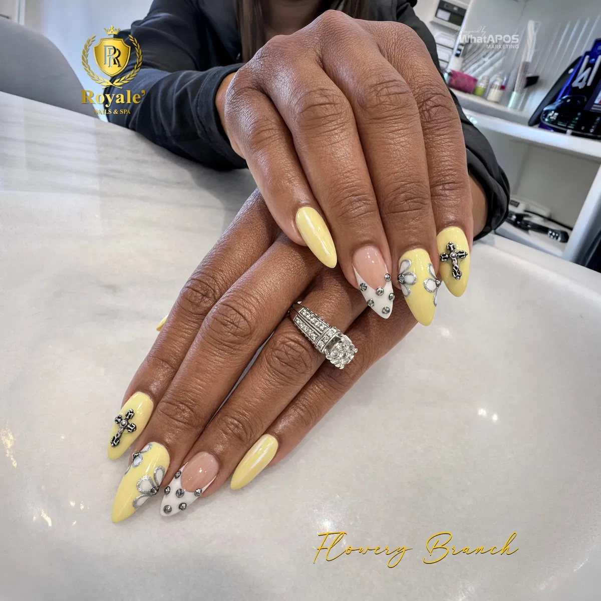 Pale yellow and nude nails with rhinestones and cross charm