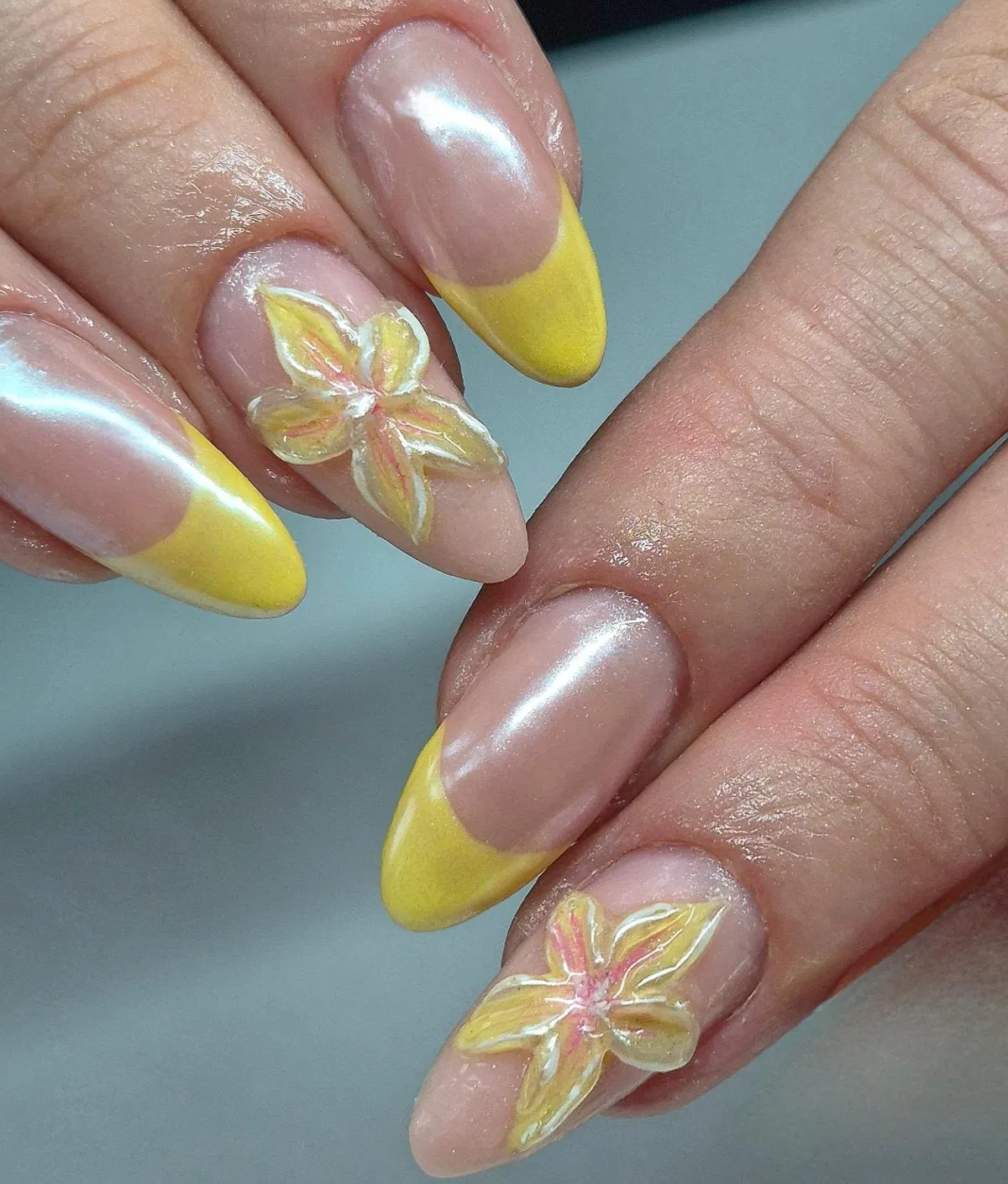 Pearly nude base with bright yellow tips and raised flowers