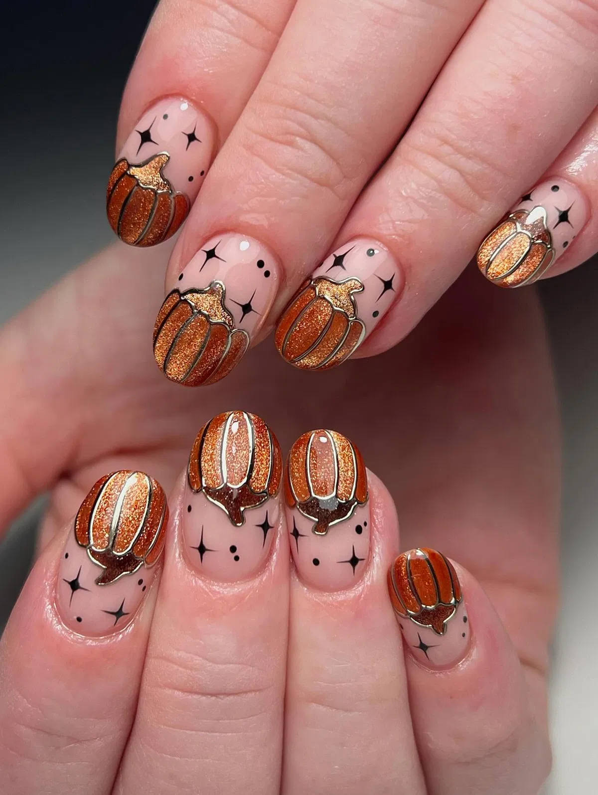Nude base with glitter pumpkin art and black sparkles