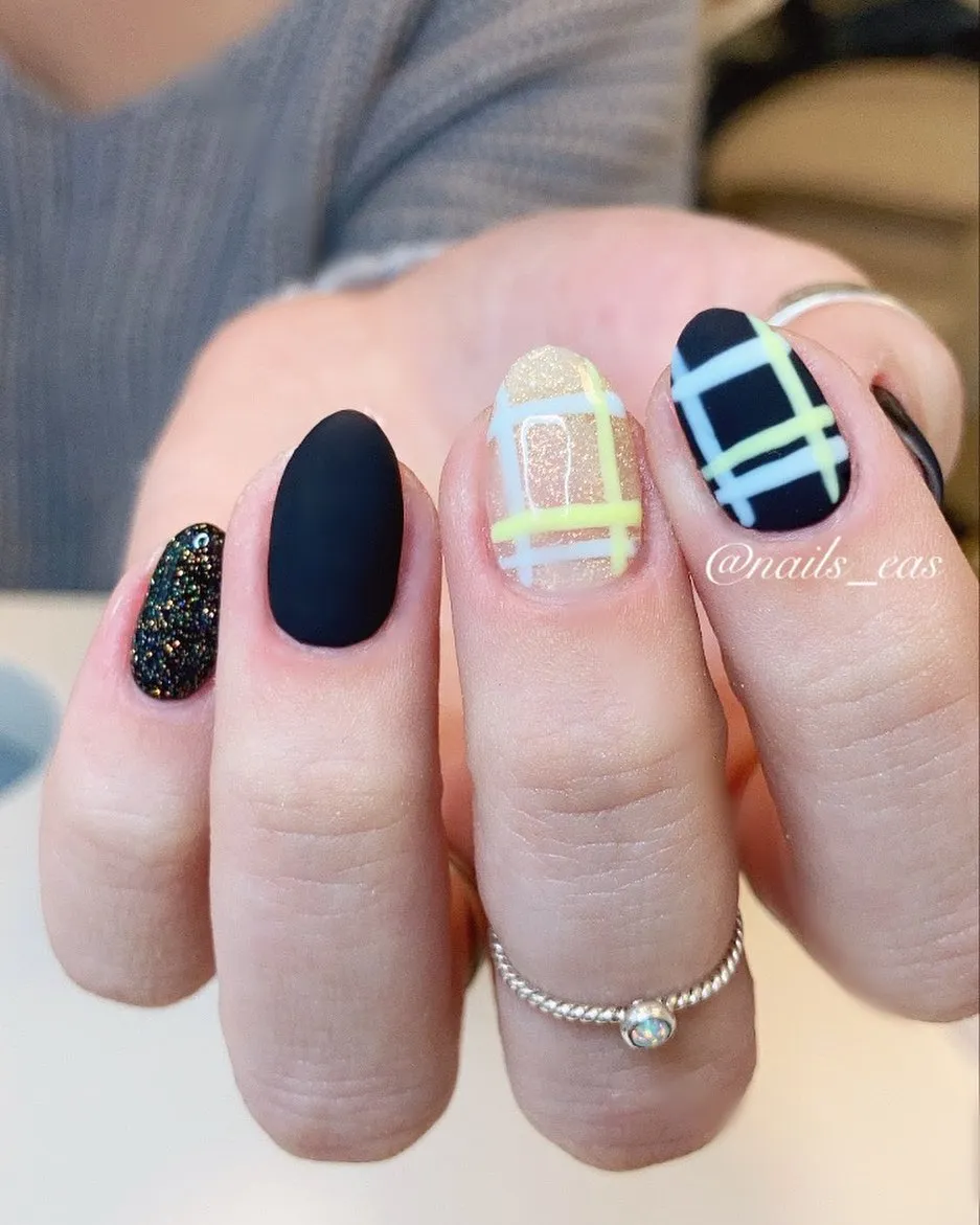 Mixed finishes with matte black, glitter accent, and pastel plaid linework