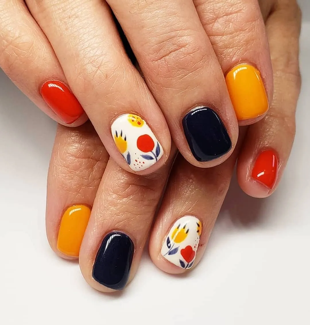 Bold solids with white-based abstract floral accent nails