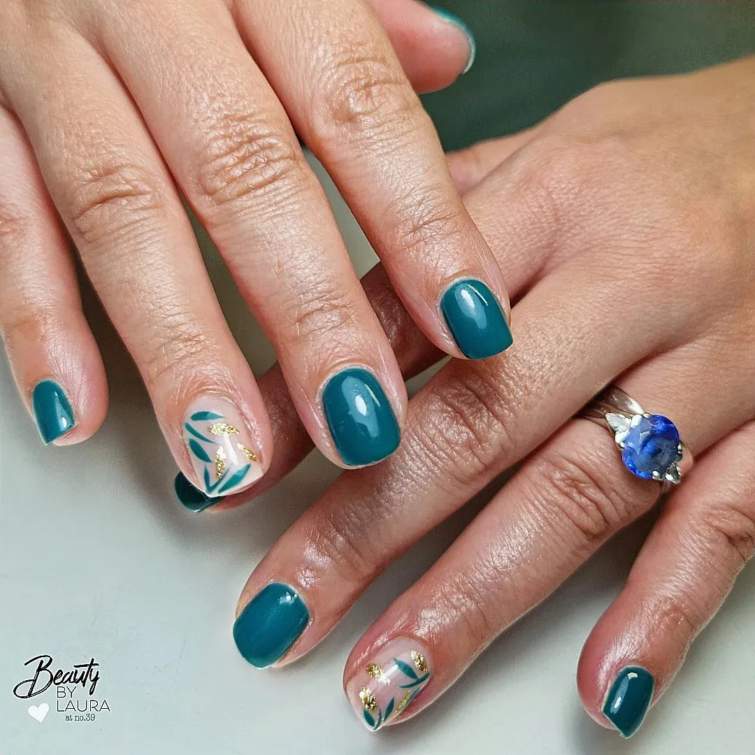 Teal manicure with nude leaf accents and gold details