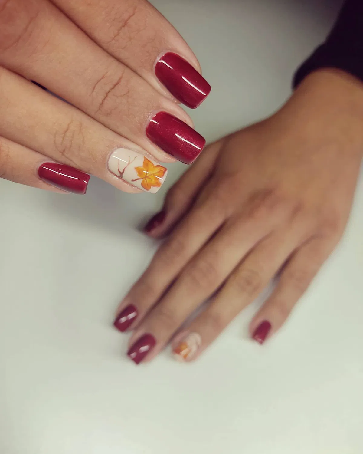 Deep burgundy set with a single orange leaf accent