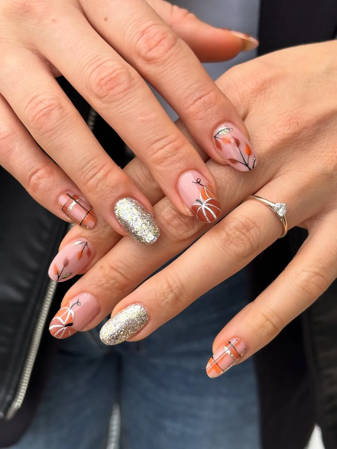 Soft pink base with pumpkins, fine lines, and silver glitter