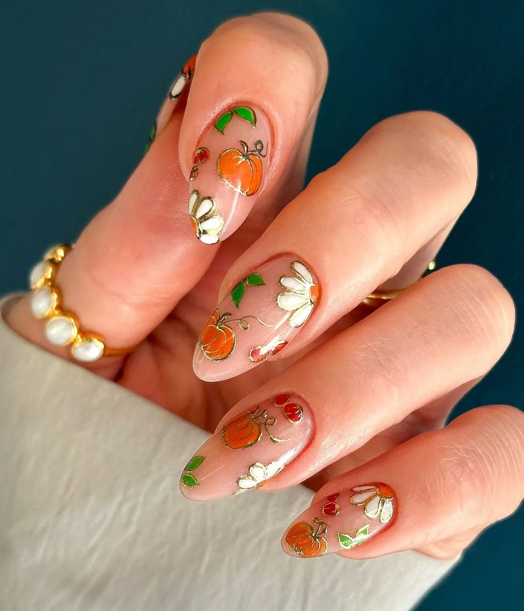 Sheer nude base with gold-outlined pumpkins and florals