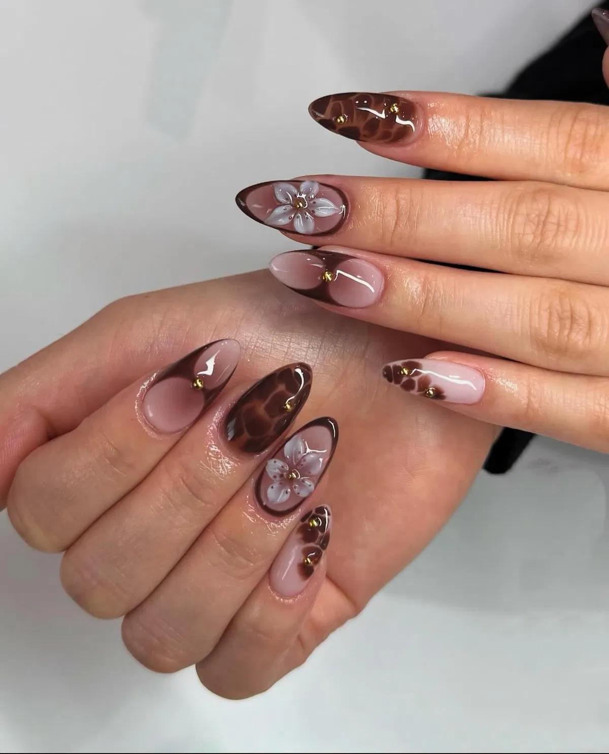 Nude-and-brown French tips with floral and tortoiseshell accents