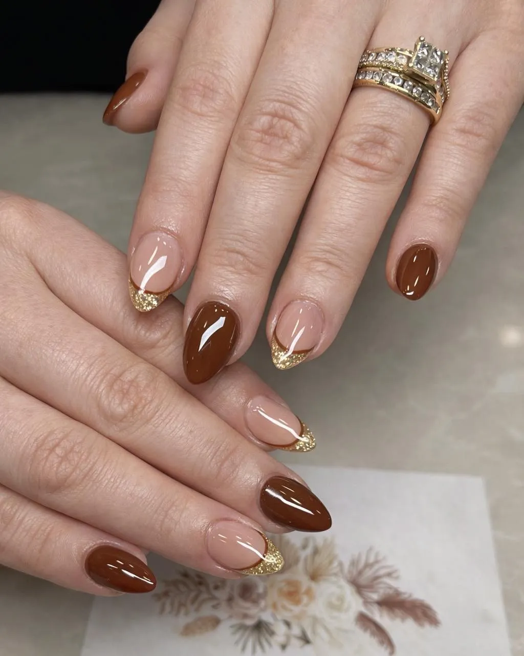 Classic brown with nude-and-gold glitter French tips