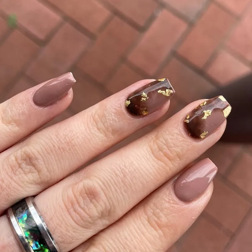 Taupe-brown nails with translucent brown and gold foil accents