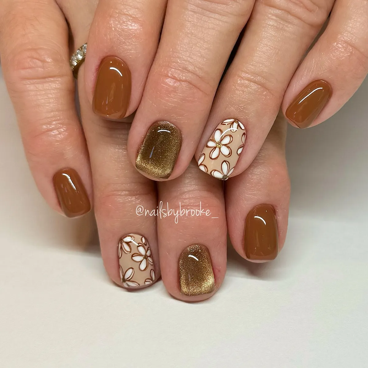 Glossy brown with gold glitter and floral accents
