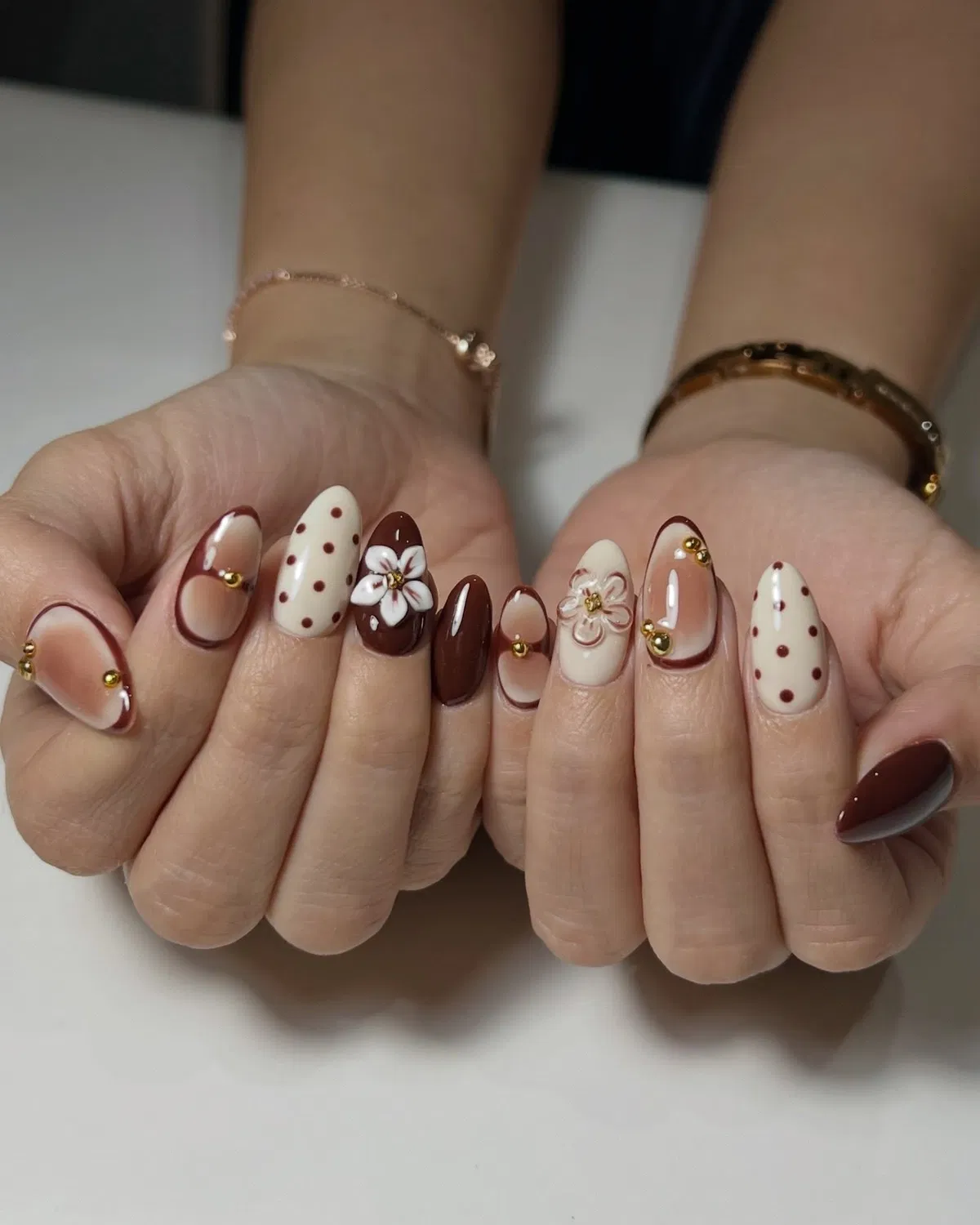 Deep brown mix with polka dots, outlined tips, and floral details