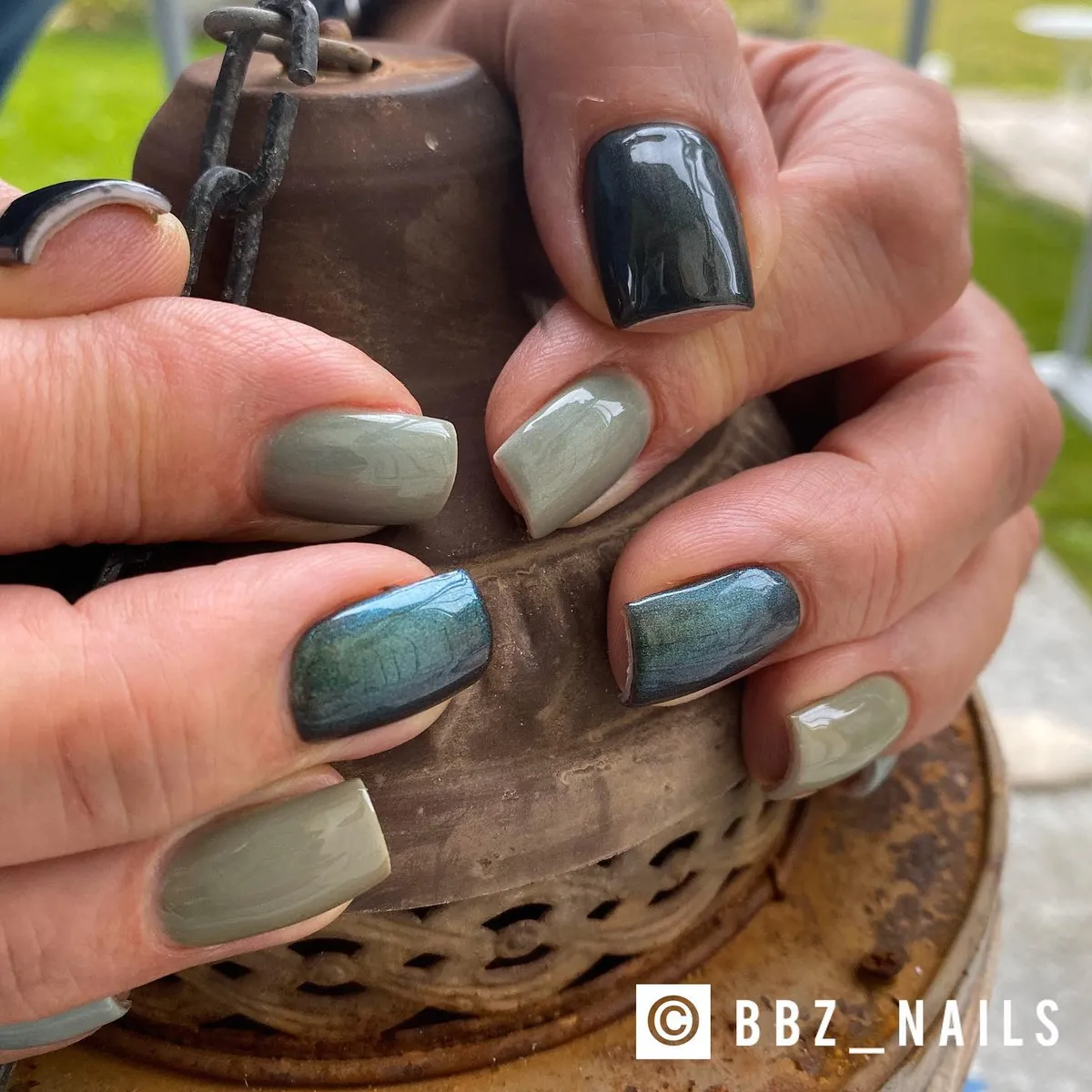 Glossy deep greens and sage with a blue-green shimmer accent