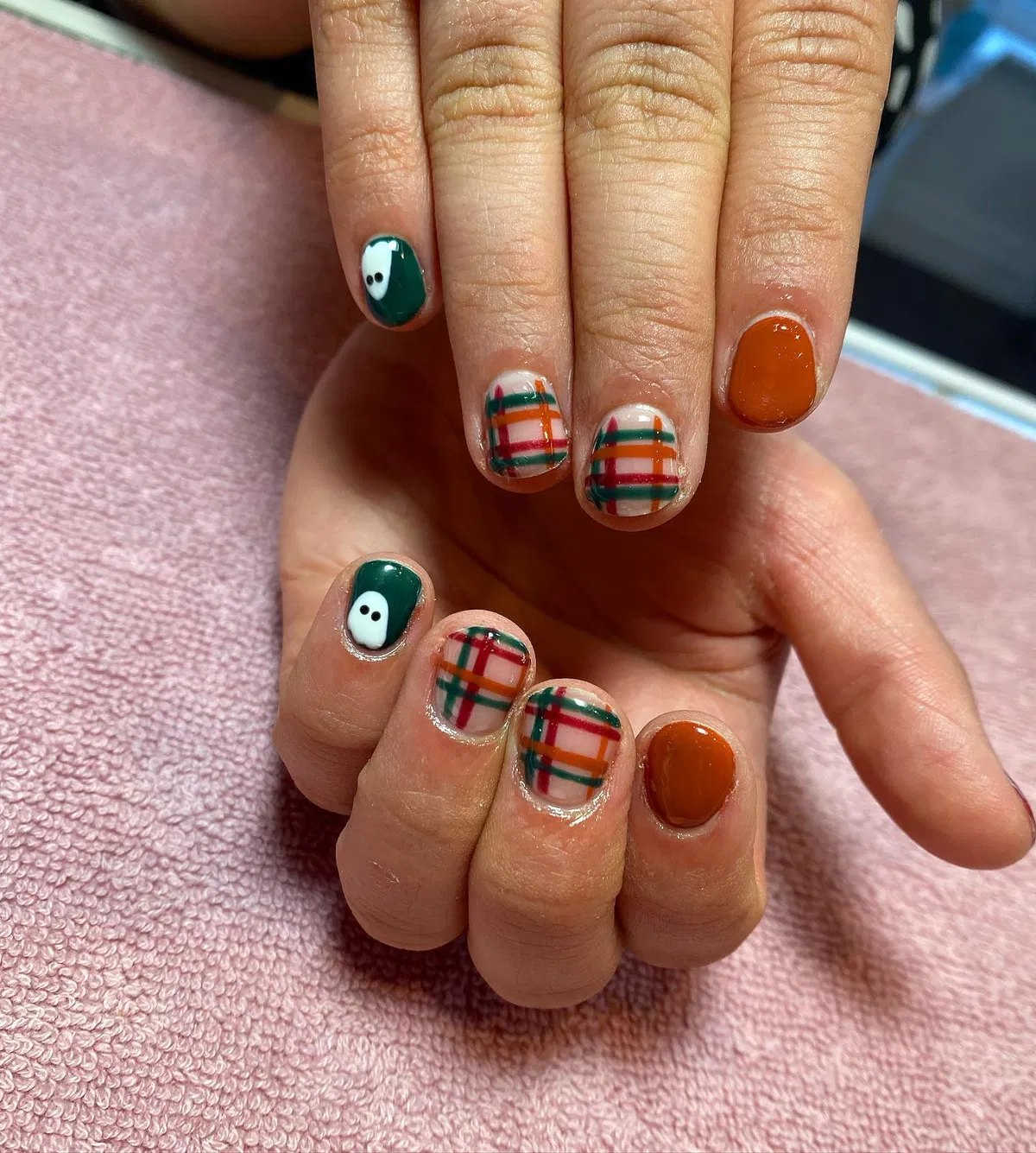 Dark green, plaid, and orange-brown with ghost accents