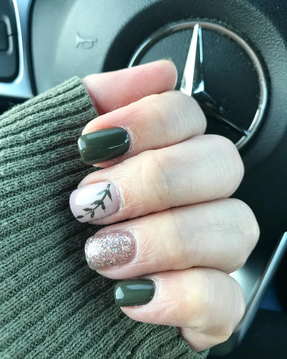 Dark green solids with leafy accent and silver glitter nail