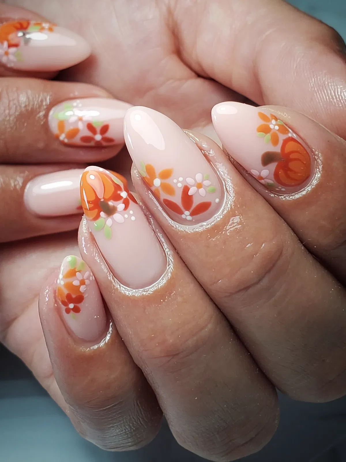 Pale pink florals with an orange pumpkin accent