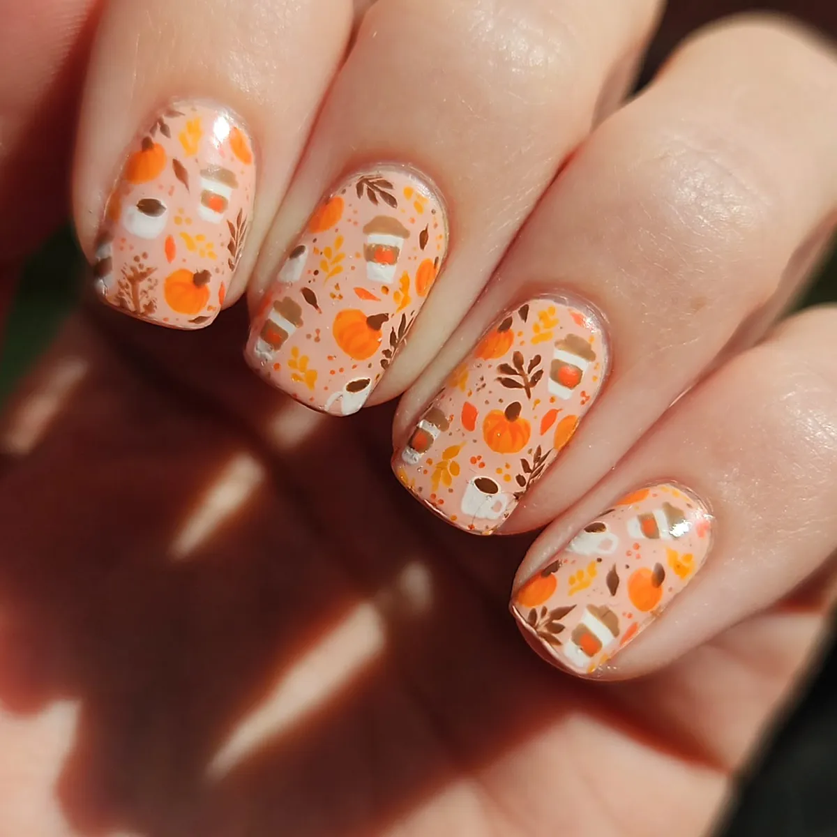 All-over autumn scatter print with pumpkins and small mug motifs