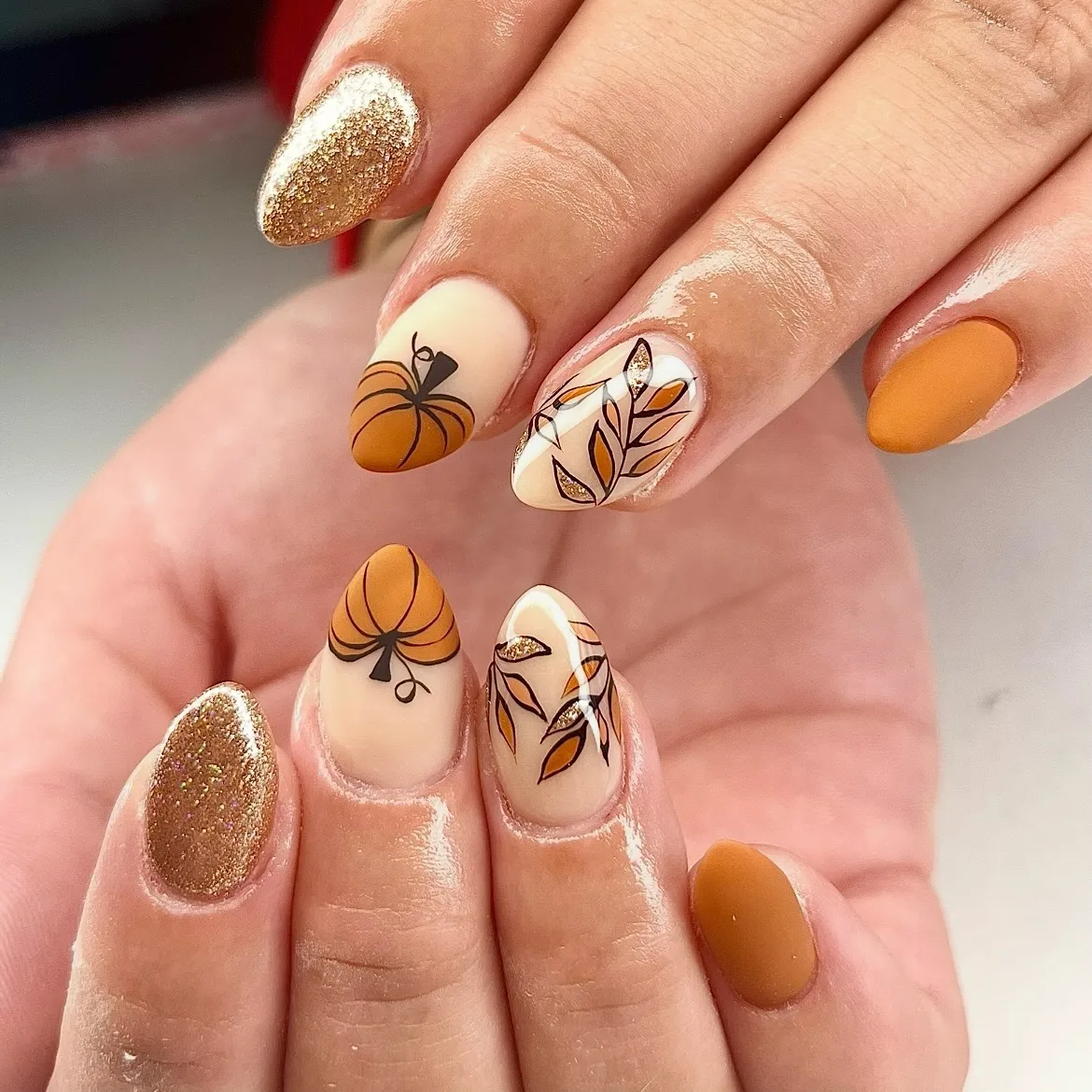 Matte mustard and gold glitter with pumpkin and leaf art