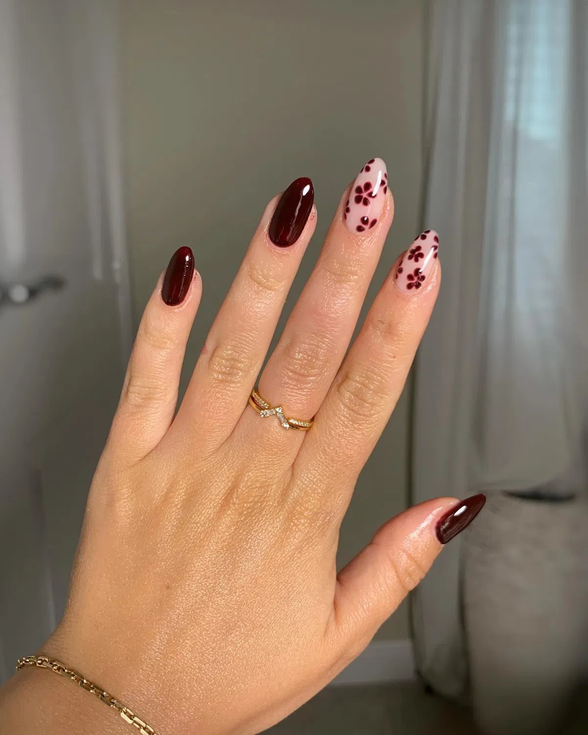 Deep burgundy solids with small floral accent nails
