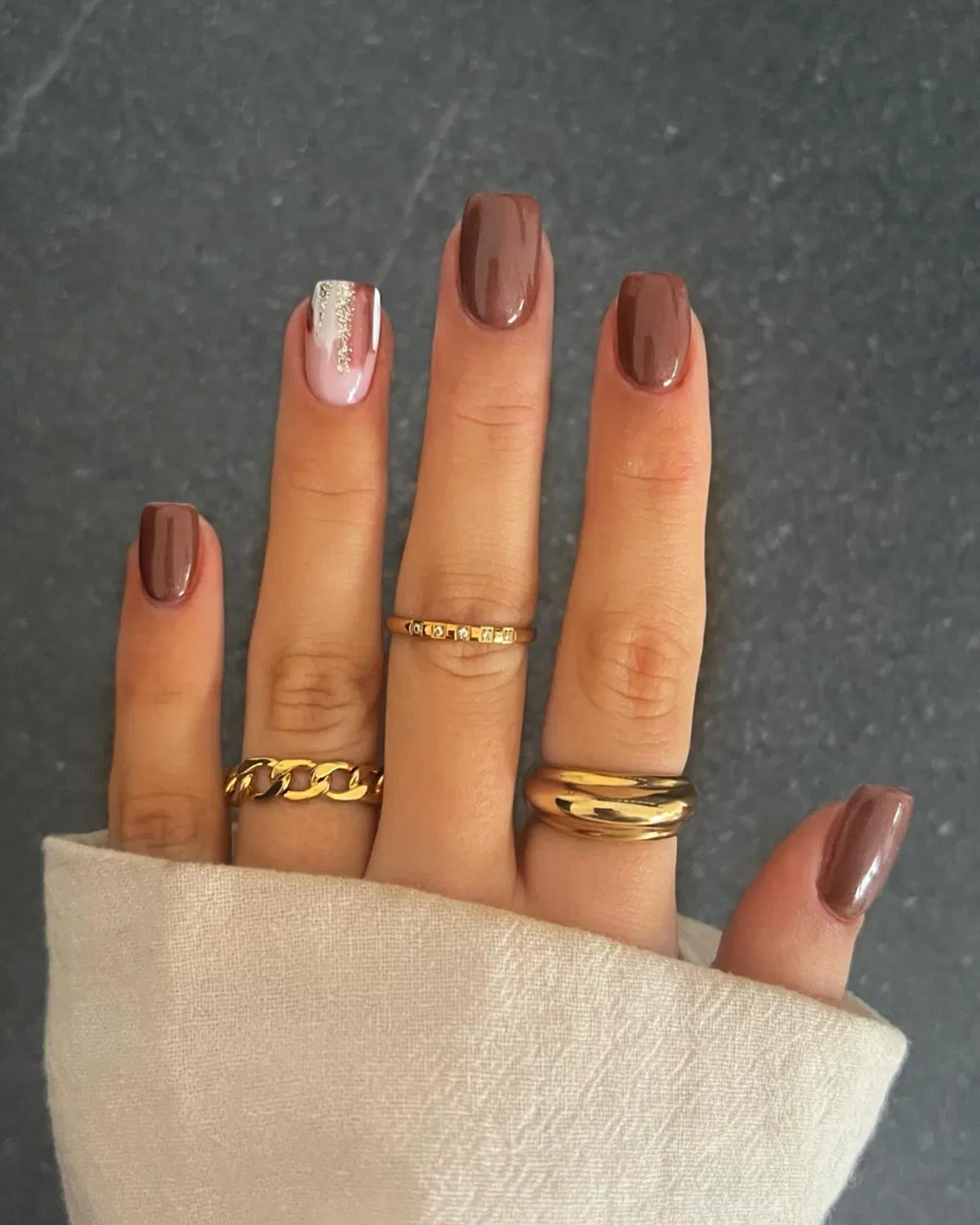 Chocolate-brown manicure with a silver-glitter accent stripe