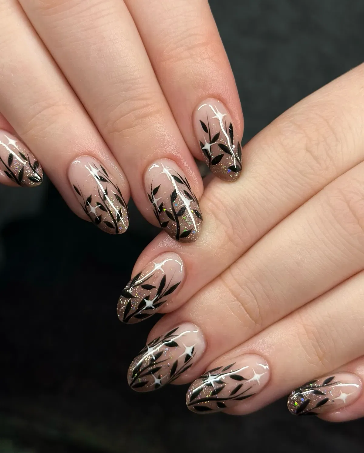 Nude-to-brown glitter ombre with black botanical silhouettes