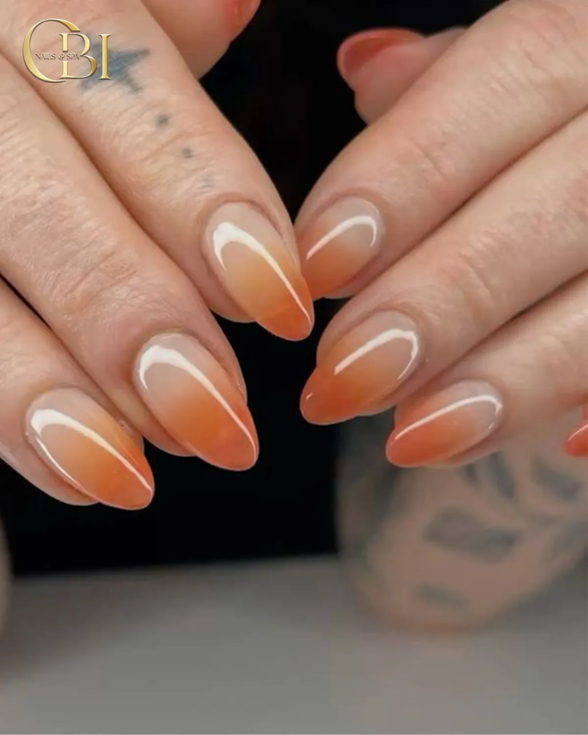 Classic nude-to-orange ombre almond nails