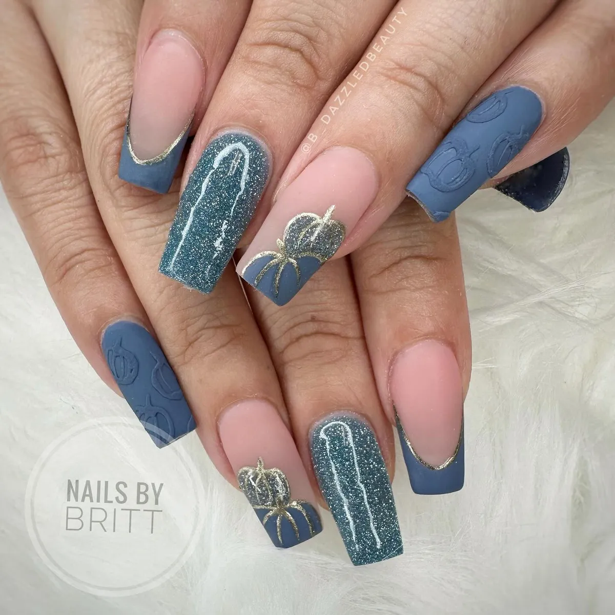 Matte dusty-blue French tips with gold edging and pumpkin details