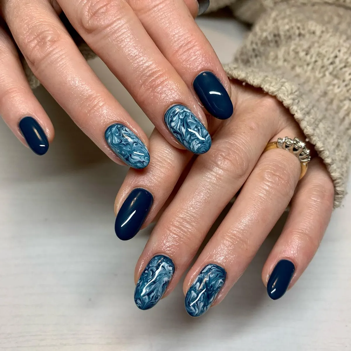 Dark navy with blue-and-white marbled accent nails