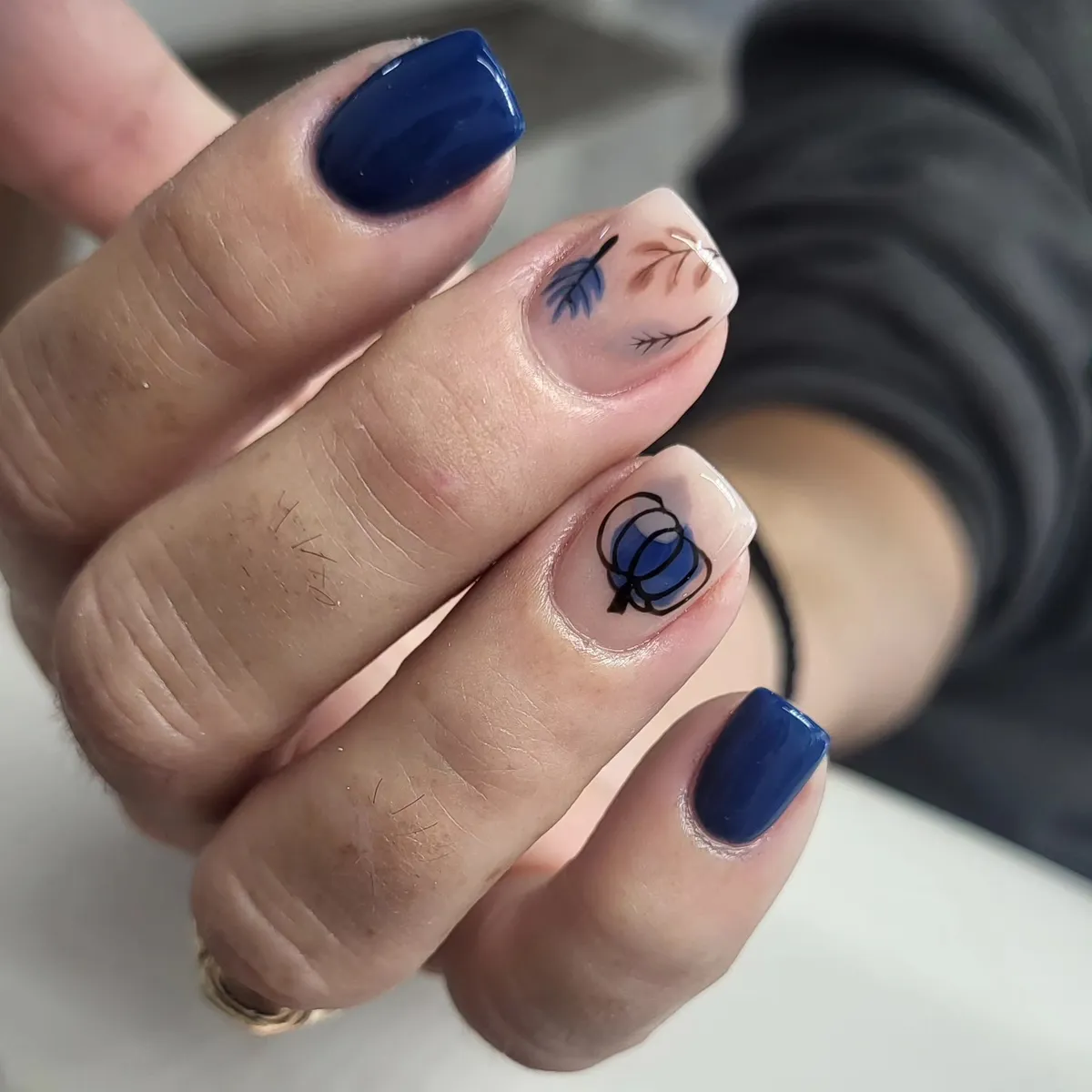 Deep navy solids with nude botanical lines and blue pumpkin outline