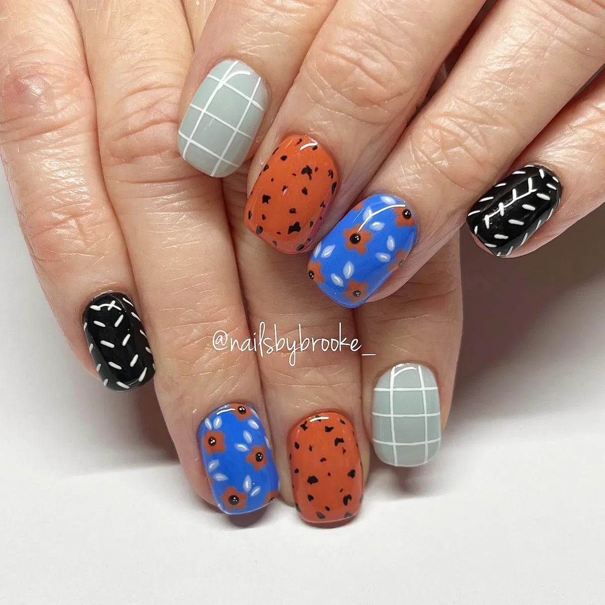 Pattern-mix set with blue florals, orange speckles, and grid accents