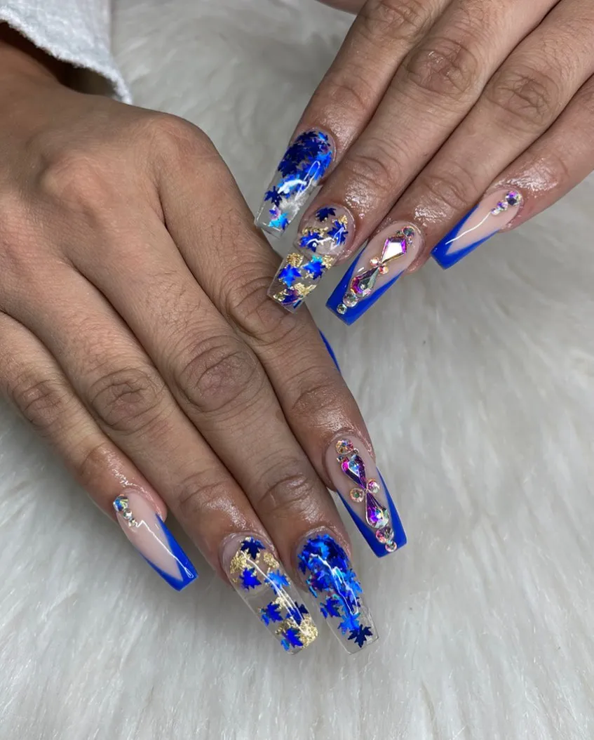 Clear-and-blue leaf pieces with bold blue French tips and gem accents